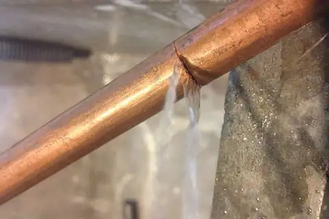 Burst copper water pipe before repair